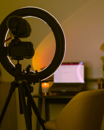 A camera with a ring light preparing for content creation.